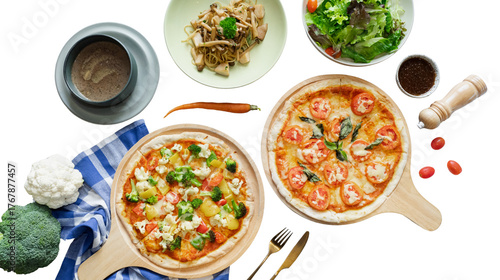 An overhead shot showcasing various delicious food items, including two pizzas with different toppings, a green salad, pasta, a bowl of sauce, and other ingredients