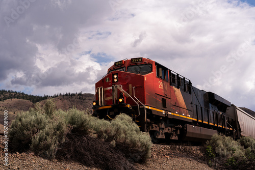 Freight train heading toward a river trestle.