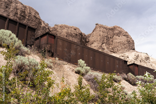Freight train heading toward a river trestle.