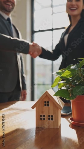 Vertical, Business People Shaking Hands Over Miniature House Model