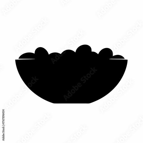 A bowl filled to the brim with rounded objects, shown in silhouette
