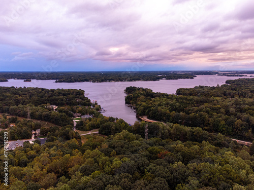 Εκτύπωση καμβά Aerial view of Lake Norman, North Carolina at sunset, with soft pink and purple light reflecting across the water and tree-covered shoreline