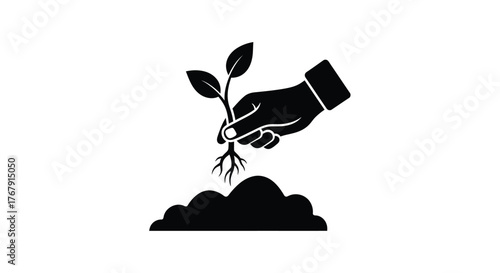 A hand gently nurturing a small plant with visible roots and soil