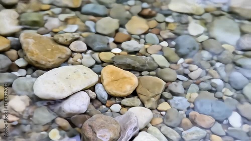 Pebbles beneath clear, shallow water