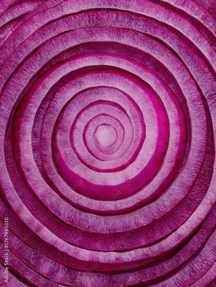Fototapeta premium Close-up View of a Vibrant Red Onion Cut Into Circular Layers Showcasing Its Unique Textures and Colors