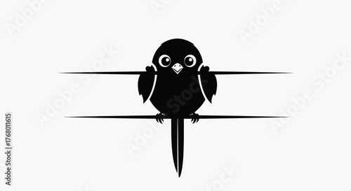 Cute black bird perched on a line