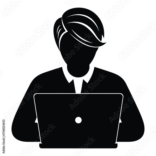 Silhouette of a person working on a laptop computer