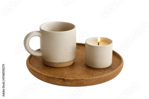 Cozy ceramic mug and lit candle on wooden tray