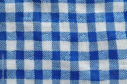 Close-up view of blue and white checkered woven fabric with textured threads