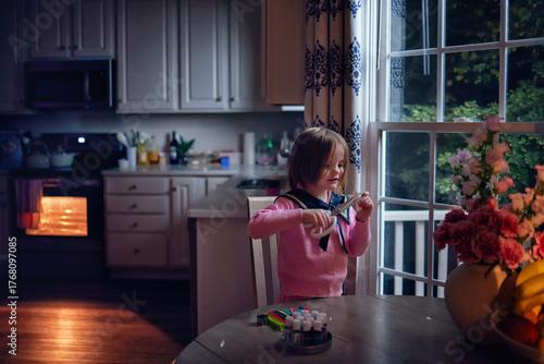 Cute Little Girl Doing Crafts in Cozy Home Kitchen by Window – Warm Night Light, Real Family Lifestyle and Evening Creativity
