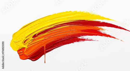 Energetic brushstroke of vibrant yellow orange and red paint on a white canvas backdrop