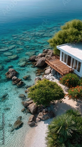 Wallpaper Mural Aerial Drone View of a White Villa on Stilts Over Crystal Clear Turquoise Water With Lush Greenery and Colorful Flowers on a Sunny Day Torontodigital.ca