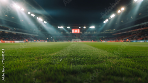 Empty soccer stadium at night with bright lights illuminating the field 