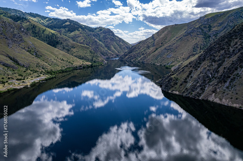 Drone photo of calm surface of Snake river, Hells Cayon. Clouds reflection in blue water