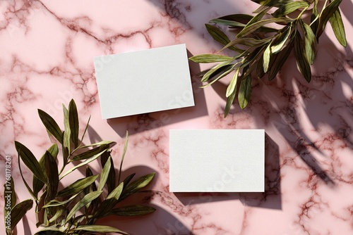 Wallpaper Mural Two white cards on pink marble, accented by leafy branches and dappled sunlight Torontodigital.ca