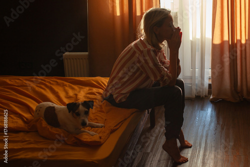 Silhouette Depressed Woman sadly sitting on Bed in dark Bedroom