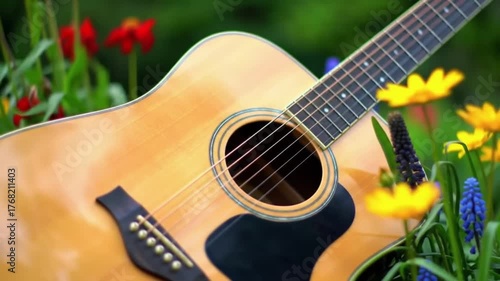 Acoustic guitar rests among vibrant spring flowers, evoking nature's melody