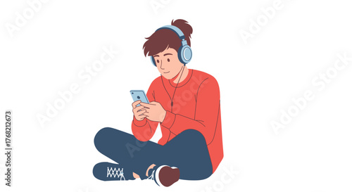 A young man with headphones sits cross-legged on the floor, looking at his smartphone with a relaxed posture against a clean white background.