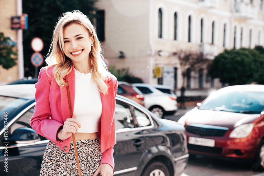 Fototapeta premium Young beautiful smiling blond hipster woman in trendy summer jacket clothes. Sexy carefree female posing in the street at sunny day. Positive model outdoors at sunset. Cheerful and happy