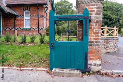 Close up of a wooden green gate on a historic property