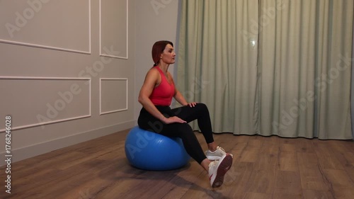 middle-aged woman doing sports exercise on the floor at home