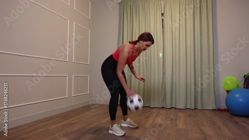 middle-aged woman doing sports exercise on the floor at home