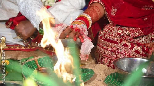 Hands of the bride and groom in wedding Ceremony. Hindu wedding ritual. Odia Wedding. Hindu Wedding Ceremony with Burning Fire and Offering Ritual with People and Golden Details.