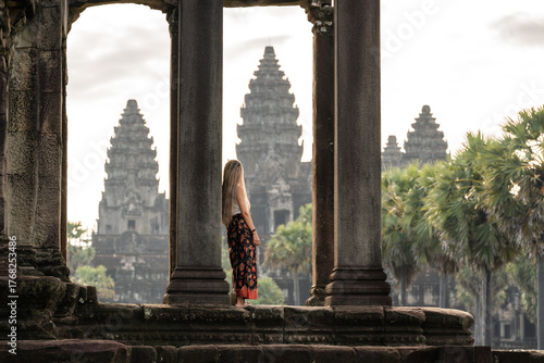 Woman traveling angkor wat admiring ancient temple architecture