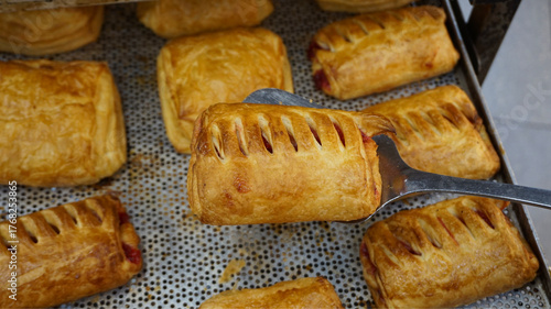 Fresh baked puff pastry on baking tray, golden crust close-up