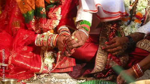 Hands of the bride and groom in wedding Ceremony. Hindu wedding ritual. Odia Wedding. Hindu Wedding Ceremony with Burning Fire and Offering Ritual with People and Golden Details.