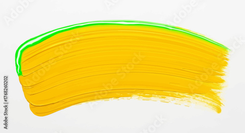 Abstract painted stroke showcasing a dynamic blend of yellow and green on canvas