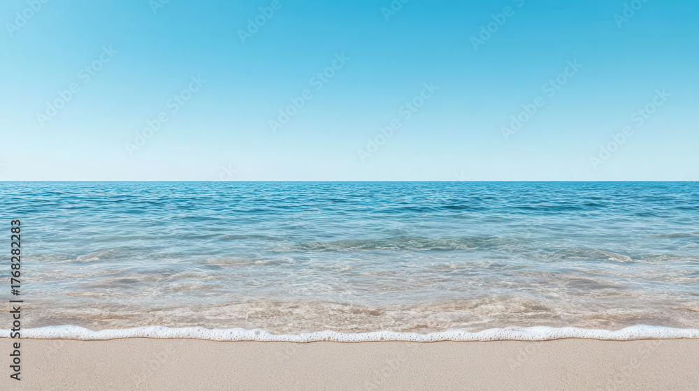 Fototapeta premium Calm seascape with clear blue sky and gentle waves lapping on sandy beach
