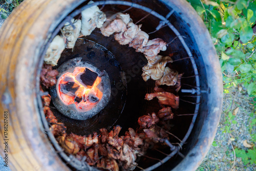 A man grills pork in a crispy, fragrant pot at a party. The crispy pork chops are a popular dish in Thailand.
