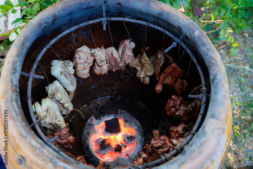 A man grills pork in a crispy, fragrant pot at a party. The crispy pork chops are a popular dish in Thailand.