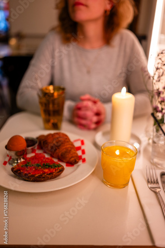 A woman in a restaurant enjoying breakfast
