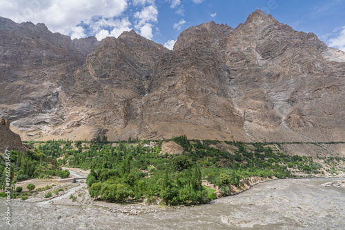 Scenic mountain landscape view of remote rural afghan village in Panj river valley in summer, Rushan, Gorno-Badakhshan, Tajikistan Pamir