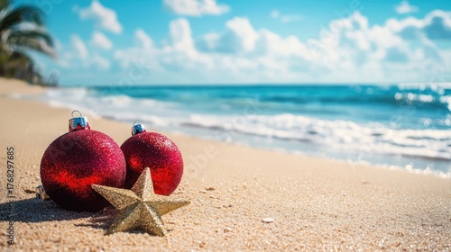 Two red Christmas ornaments on a sandy beach with a starfish and palm trees in the background.