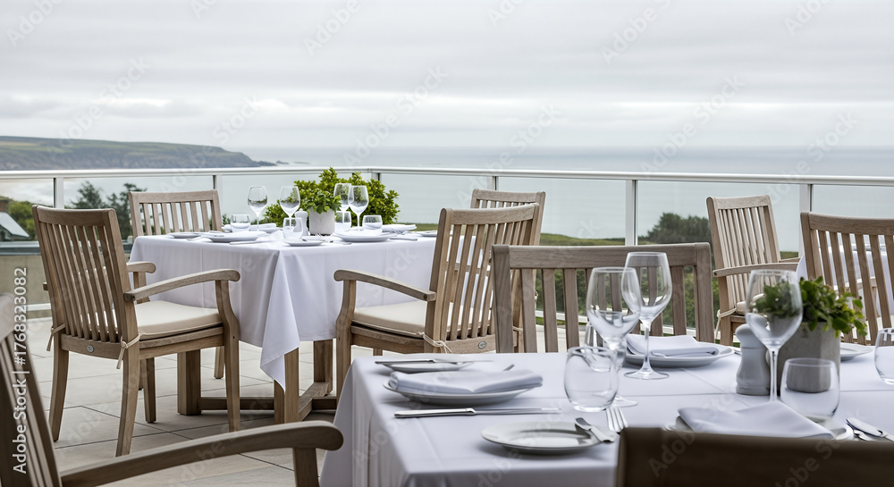 Fototapeta premium Restaurant tablescape presents elegant dining on a coastal terrace