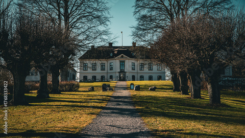 Historic mansion with park in early spring light