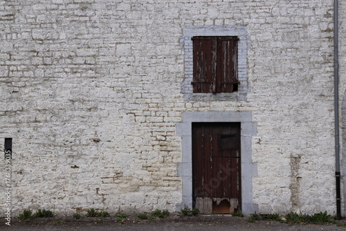 Old Window in Brick Wall
Weathered window framed by aged, cracked, and neglected bricks.

