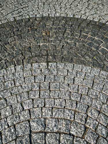 Slika na platnu A close-up of gray granite pavers laid in a semicircular arc