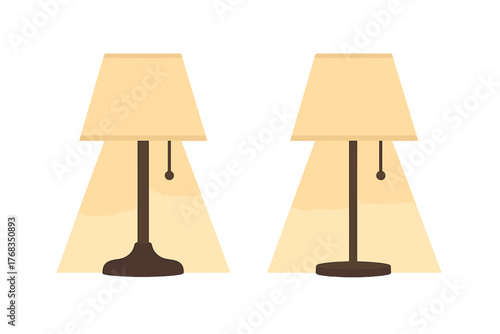 Pair of traditional table lamps with beige shades casting a warm glow on a white background