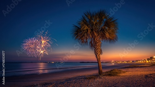 Colorful fireworks burst in the night sky above the serene beach while a palm tree stands tall.