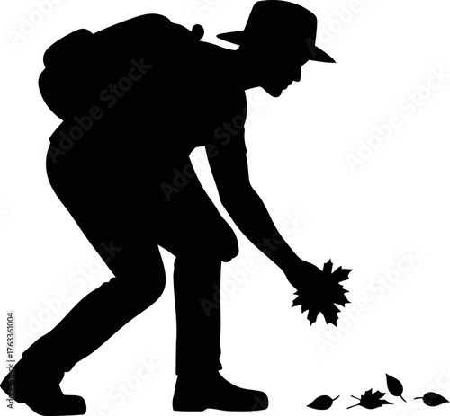 natures custodian gathers fallen leaves, embracing earths gentle art