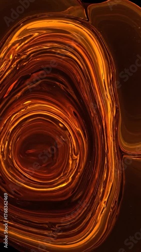 Abstract, fluid artwork with swirling layers of orange and brown tones, black background