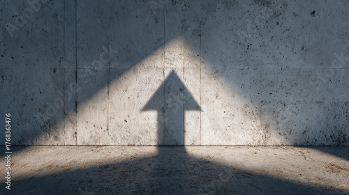 arrow shadow on concrete wall, representing growth and direction