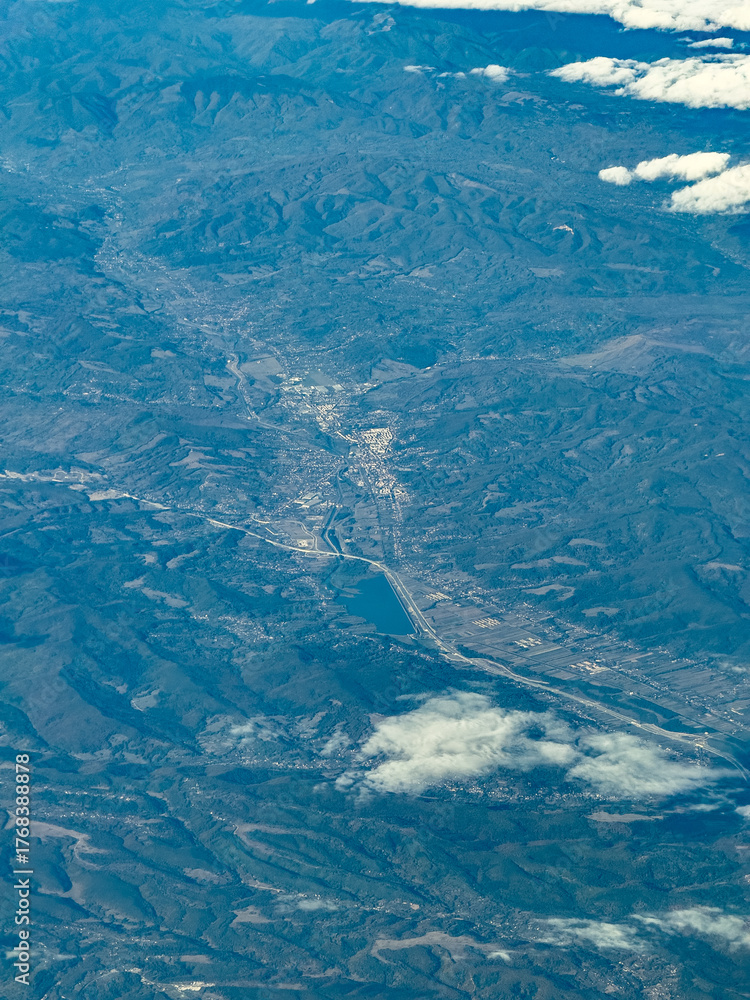 Naklejka premium aerial view of mountain landscape around Curtea de Argeș a city in Romania on the left bank of the river Argeș in a valley of the Southern Carpathian's with lake Zigoneni