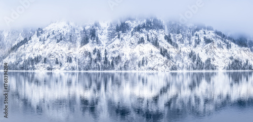 Bild auf Leinwand A tranquil winter landscape with snowcovered mountains and seren