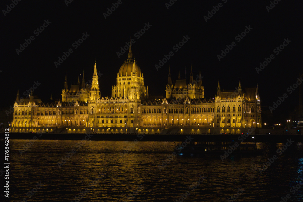 Fototapeta premium Hungarian Parliament in Budapest at night across the river Danube