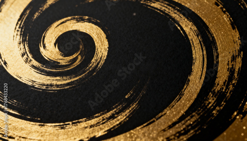 High resolution picture of golden textured spiral brush stroke on a black background. Abstract luxury art design.